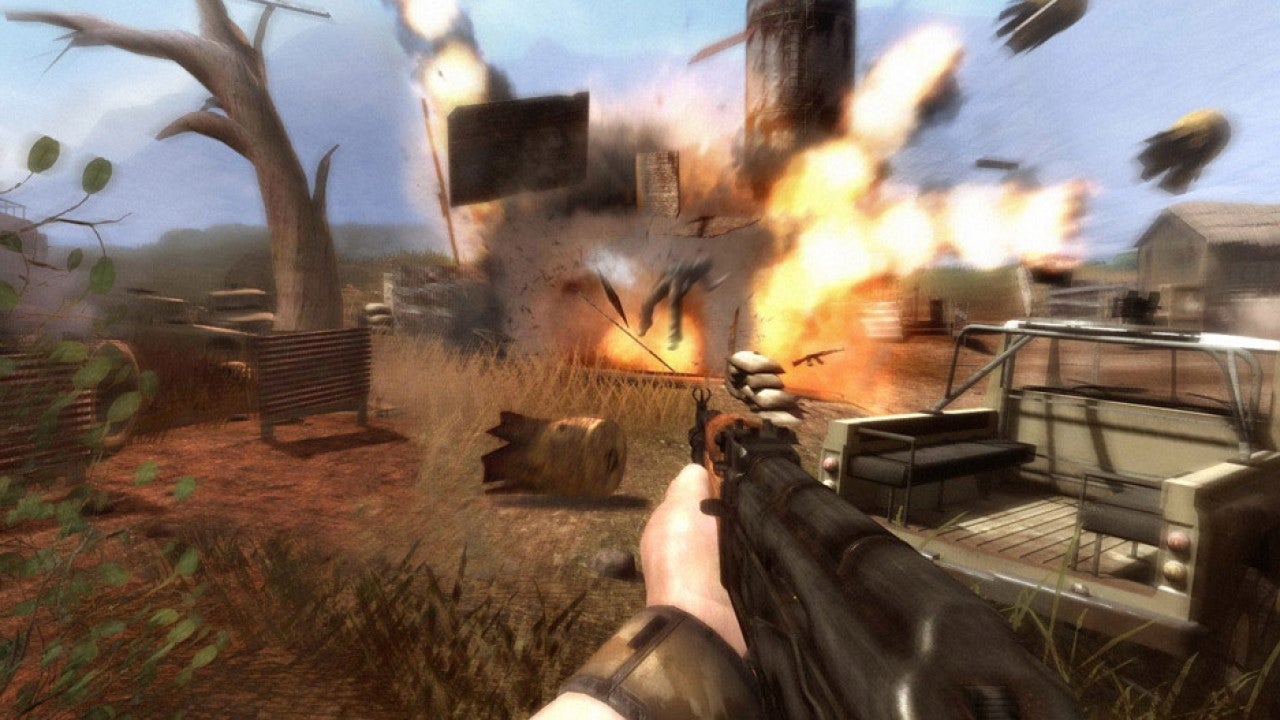 An image from Far Cry 2 which shows the player aiming an AK47 at a huge explosion.
